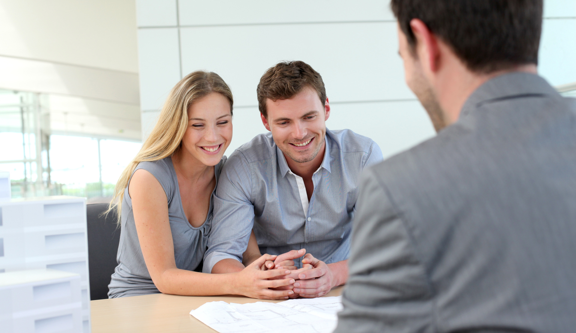 Happy couple in sales office